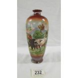 A Victorian hand painted vase depicting 2 cows in a field with a background of mountains signed H