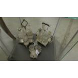 3 silver plate cruets with glass bottles.