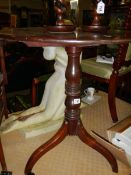 A mahogany tripod table.