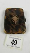 A Tortoise shell cigarette case with gold monogram and silver hinge, dated May 6th 1925.