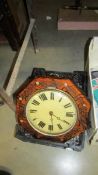 An octagonal wall clock with 2 brass weights.