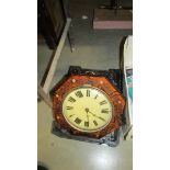 An octagonal wall clock with 2 brass weights.