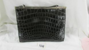 An Asprey black crocodile hand bag with hall marked silver mount.