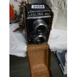 A cased vintage Halina camera.