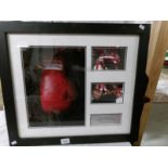 A framed boxing glove signed by Chris Eubank and Tony Ben.