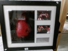 A framed boxing glove signed by Chris Eubank and Tony Ben.