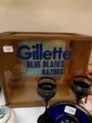 A glazed shop cabinet with Gillette lettering.