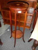 An Edwardian mahogany inlaid pot stand.