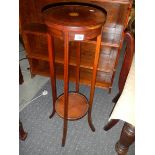 An Edwardian mahogany inlaid pot stand.