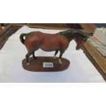 A brown Beswick horse, in good condition.