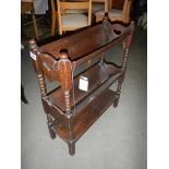 An oak book rack. ****Condition report**** Length 58.5cm. Height 72cm. Depth 11.