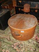 A circular hat box full of linen.