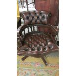 A superb quality deep buttoned brown leather captain's chair.