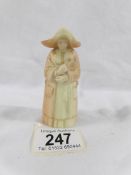 An early Royal Worcester candle snuffer in the form of a nun.