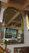 A large arched top bevel edged multi coloured mirror with deep cut vase of flowers decoration.