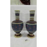 A pair of antique (1808) German Geschutzt Mettlach vases with bulbous bodies,