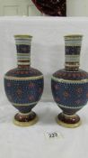 A pair of antique (1808) German Geschutzt Mettlach vases with bulbous bodies,