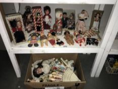 A large collection of vintage dolls in nation dress, (2 shelves).