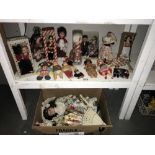 A large collection of vintage dolls in nation dress, (2 shelves).