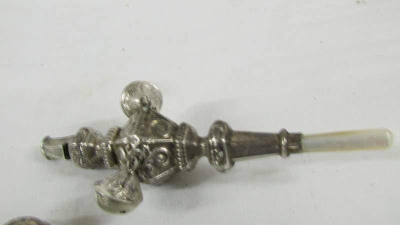 A silver 1906 babies rattle/teether and a silver plate rattle as a policeman. - Image 2 of 3