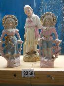 A pair of early 20th century bisque figures and one other.