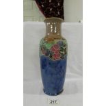 A doulton 30 cm vase with stylised decoration of fruit and leaves around the top of the body before