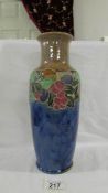 A doulton 30 cm vase with stylised decoration of fruit and leaves around the top of the body before