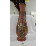 A 44 cm tall brown vase painted with parrots on and branch with other applied decoration,