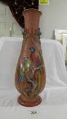 A 44 cm tall brown vase painted with parrots on and branch with other applied decoration,