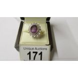 An 18ct gold diamond and amethyst ring, size N.