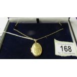 A 9ct gold locket and chain. 8.8 grams.
