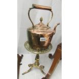 A Victorian copper kettle on a good quality Victorian brass trivet.