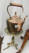A Victorian copper kettle on a good quality Victorian brass trivet.