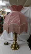 A good quality brass table lamp with lovely pink fringed shade.