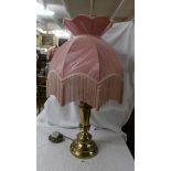 A good quality brass table lamp with lovely pink fringed shade.