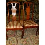 A pair of high backed dining chair.