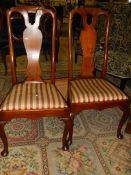 A pair of high backed dining chair.