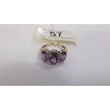 A 3 stone diamond and amethyst ring in a cluster style, deep colour amethyst in a gold tested shank.