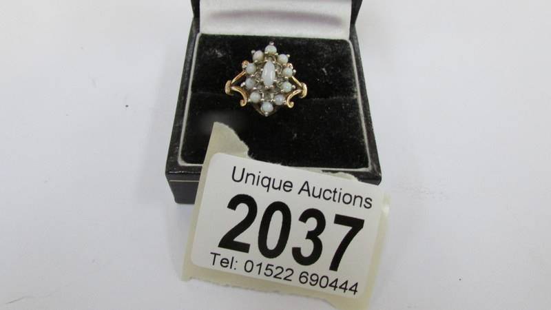 A 9ct gold ring set pearls, size K.