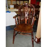 A wheel back Windsor chair. ****Condition report**** Doesn't sit flat on floor.