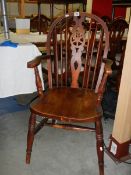 A wheel back Windsor chair. ****Condition report**** Doesn't sit flat on floor.