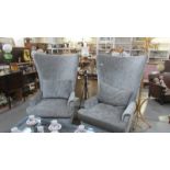 A pair of superb quality high back easy chairs.