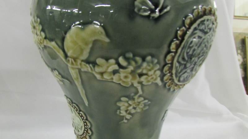 A Doulton Lambeth 26 cm vase decorated with birds, butterflies, - Image 3 of 5