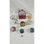 8 assorted glass paperweights.