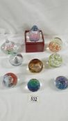 8 assorted glass paperweights.