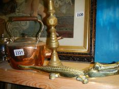 An oval copper kettle, a brass candlestick and a brass crocodile.