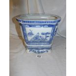 A blue and white Chinese pot on stand.