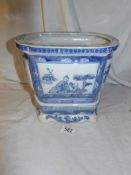 A blue and white Chinese pot on stand.