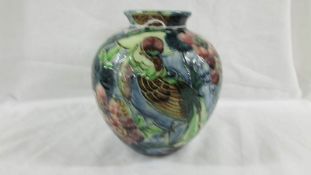 A beautiful antique Trojan 15cm high posy vase painted with flowers and a bird, signed R Dean.