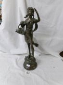 A bronze figure of an Italian girl holding a basket of flowers.